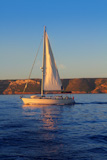 Sailboat+sailing+golden+sunrise+in+blue+ocean+sea