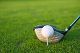 Golf+tee+ball+club+driver+in+green+grass+course+closeup