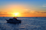 Sunrise+fishing+boat+blue+sea+orange+sky+in+Mediterranean