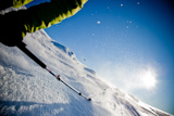 Freerider+skier+moving+down+in+snow+powder+at+sunset+%28detail%29