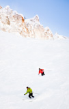 Two+skiers+going+downhill+in+powder+snow+Mont+Blanc+Courmayeur+Italy