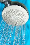Shower+with+drops+of+water+on+a+blue+background.