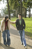 Attractive+Urban+Couple+Walking+Together+In+A+City+Park