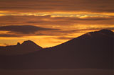 Mountain+Range+Silhouetted+By+A+Golden+Sunset