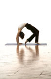 Woman+Doing+Yoga+On+A+Hardwood+Floor