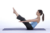 Woman+in+Seated+Balancing+Yoga+Pose+on+Mat