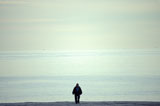 Man+Walking+Along+An+Empty+Beach