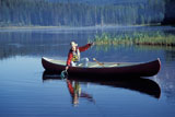 Caucasian+Cowboy+Fishing+From+A+Canoe+In+A+Mountain+Lake