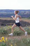 Caucasian+Woman+Jogging+Along+A+Mountain+Mesa