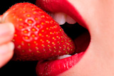Macro+close+up+of+a+beautiful+female+mouth+eating+a+fresh+strawberry