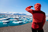 Female+hiker+looking+across+the+Iceberg+Lagoon%2C+Jokulsarlon%2C+Iceland+filled+with+glacial+Icebergs+with+the+Vatnajokull+Glacier+in+the+background%2C+Europe%27s+biggest+glacier.+The+focus+is+on+the+Icebergs.+Shot+in+summer+2009+when+the+lagoon+had+the+greatest+number+of+icebergs+for+decades.
