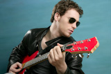guitar+rock+star+man+sunglasses+and+leather+perfect+jacket+over+blue