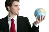 businessman+tien+suit+with+world+ball+global+map+in+hand+power+communication+metaphor