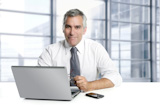 businessman+senior+gray+hair+working+laptop+interior+modern+white+office
