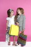Little+shopper+humor+shopaholic+two+girls+stand+full+length+pink+background