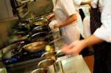 Restaurant+kitchen+staff+busy+at+work+at+the+stove.