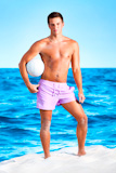 Young+man+with+ball+on+beach.