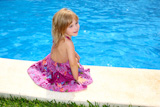 Little+blond+girl+sitting+smiling+swimming+pool+outdoor