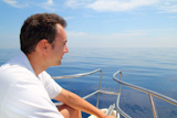 Sailor+man+sailing+boat+blue+calm+ocean+water+Mediterranean+sea