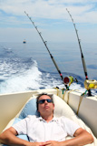 Sailor+man+fishing+resting+in+boat+summer+vacation+blue+sea