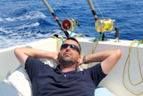 Sailor+man+fishing+resting+in+boat+summer+vacation+blue+sea