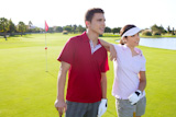 Golf+course+young+happy+players+couple+stand+up+posing+on+green