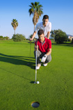 young+man+playing+golf+looking+and+aiming+for+the+hole+