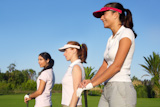 Golf+three+woman+in+a+row+green+grass+course+players