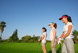 Golf+three+woman+in+a+row+green+grass+course+players