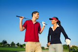 Golf+course+young+happy+players+couple+talking+posing+on+bunker