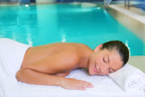 spa+pool+woman+relaxed+on+white+towel+near+water