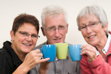 Three+seniors+holding+a+cup+of+coffee.