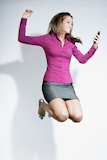 businesswoman+jumping+with+mobile+phone+in+hands