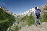 Male+hiker+enjoying+the+view+over+the+beautiful+landscape+of+Mige+Lake%2C+Mont+Blanc%2C+Courmayeur%2C+Italy