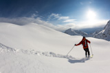 Freerider+skier+moving+down+in+snow+powder%3B+italian+alps.