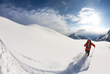 Freerider+skier+moving+down+in+snow+powder%3B+italian+alps.