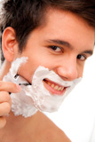 Man+shaves+with+a+razor+blade+and+shaving+cream