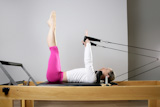 gym+woman+pilates+stretching+sport+in+reformer+bed+instructor+girl