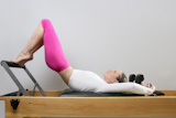 pilates+reformer+woman+gym+fitness+teacher+legs+exercise