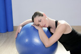 aerobics+fitness+woman+relax+pilates+stability+blue+ball+in+sport+gym