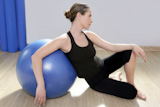 aerobics+fitness+woman+relax+pilates+stability+blue+ball+in+sport+gym
