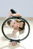 magic+pilates+ring+woman+aerobics+sport+gym+exercises+on+wooden+floor