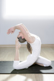 yoga+woman+fitness+girl+in+white+meditation+at+gym+on+mat