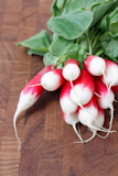 A+bunch+of+radishes+on+a+wooden+backgroung