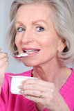 Portrait+of+senior+woman+eating+yoghurt