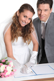 Bride+and+groom+signing+marriage+contract