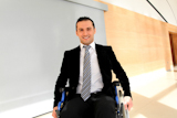 Businessman+in+wheelchair+going+to+attend+congress+meeting