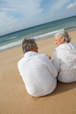 Senior+couple+in+bathrobe+at+the+beach