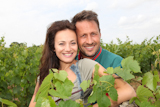 Happy+couple+of+winegrowers+in+vineyard