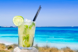 Cocktail+mojito+ice+lemon+straws+in+tropical+beach+balearic+Islands